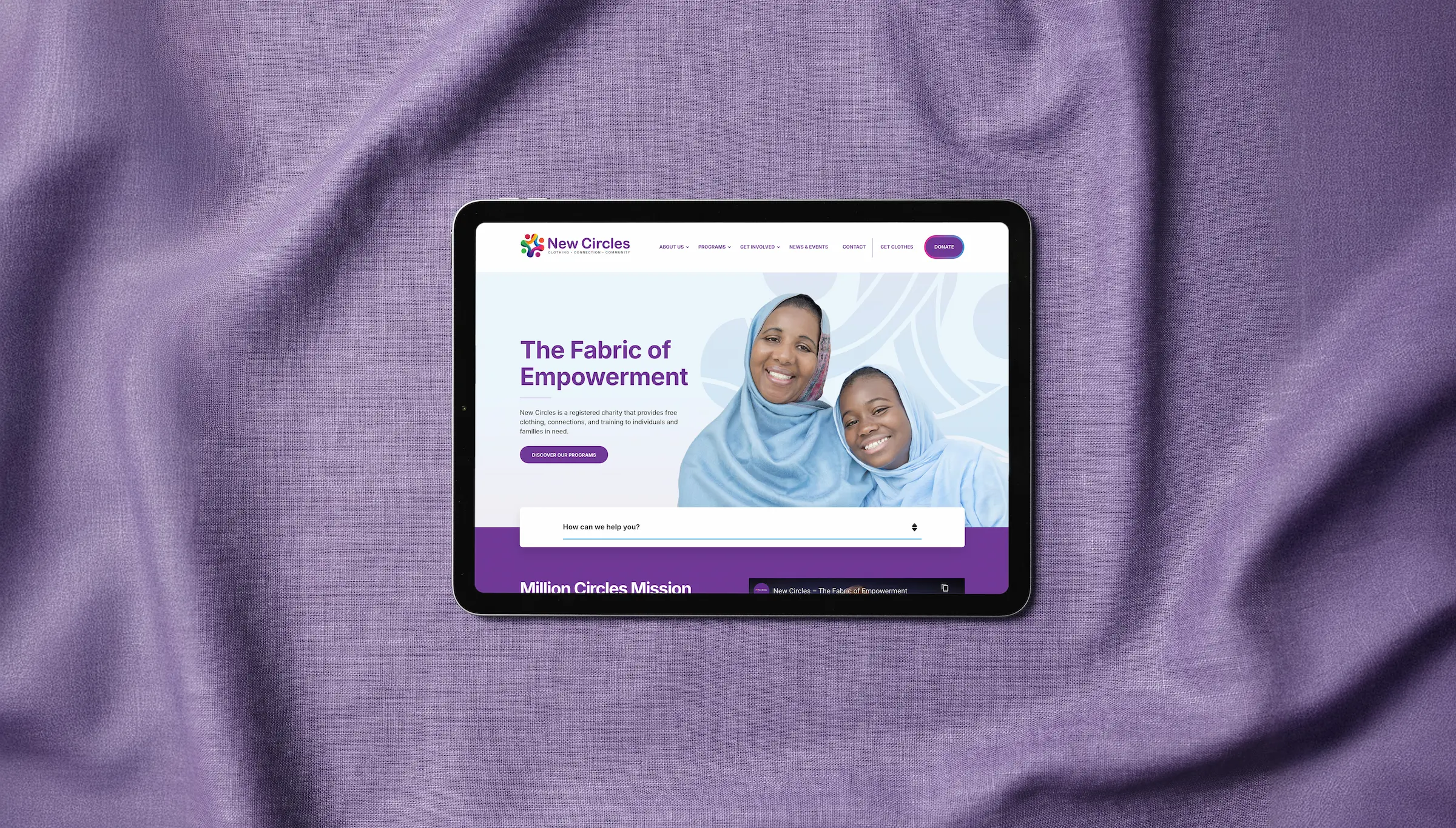 New Circles homepage hero on a tablet device displayed on top of purple fabric.